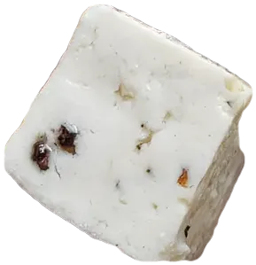 A cube of PANEVO Black Pepper paneer with whole peppercorns set inside